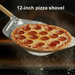 Pizza being lifted from oven