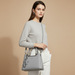 Woman holding grey PU handbag